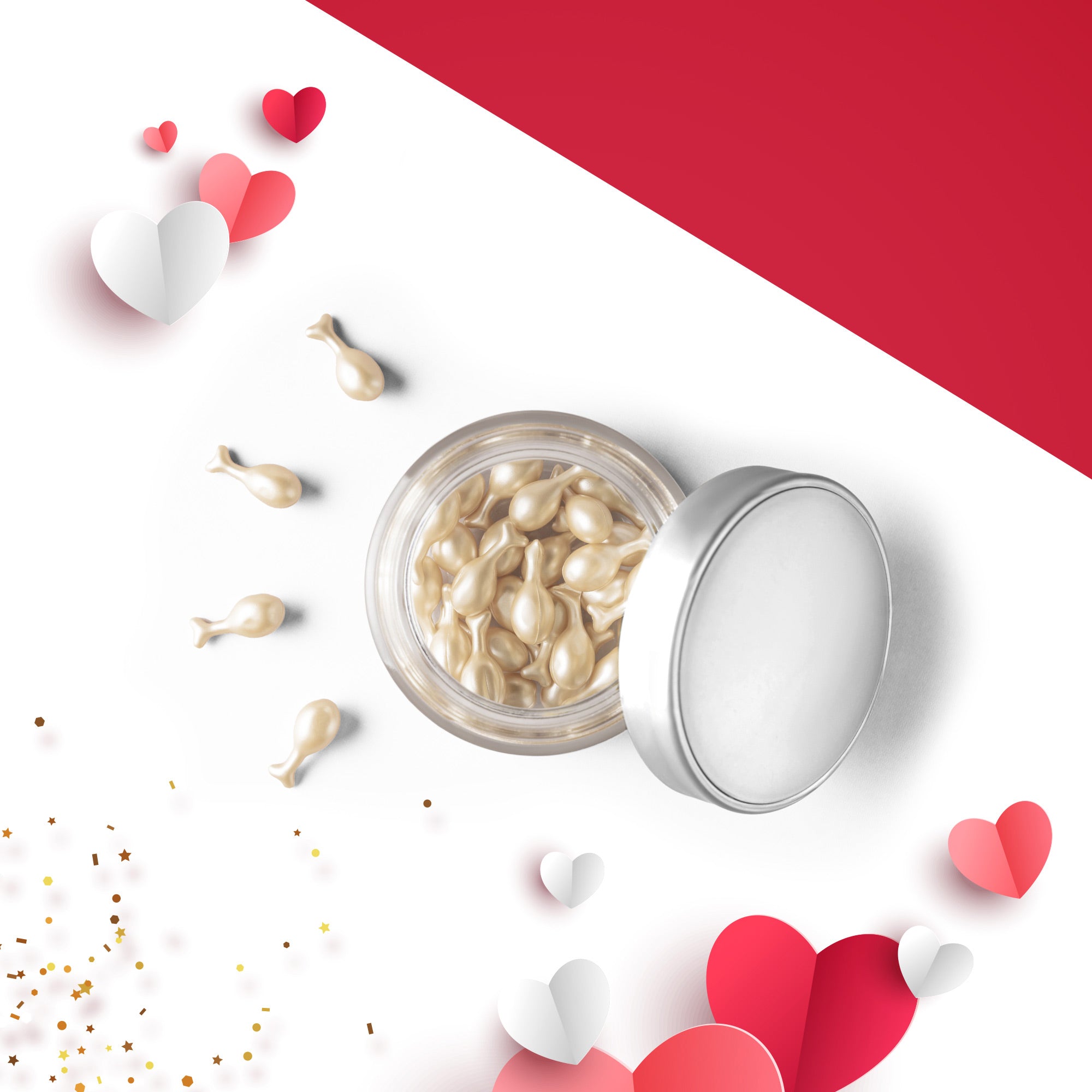 Offene runde Dose mit perlfarbenen Öl-Kapseln, einige Kapseln liegen davor. Die Dose befindet sich auf einem weiß-roten Hintergrund, umgeben von Papierherzen in Rot, Rosa und Weiß sowie goldenen Konfettipunkten.